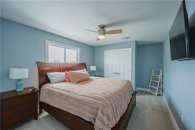 bedroom with carpet flooring, visible vents, a closet, and baseboards