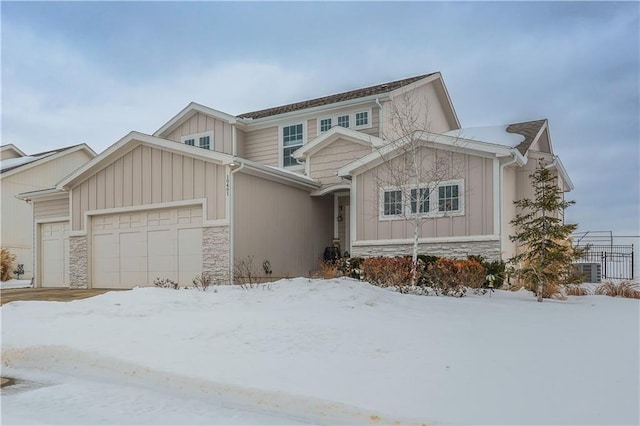 view of front of house with board and batten siding, a garage, and stone siding