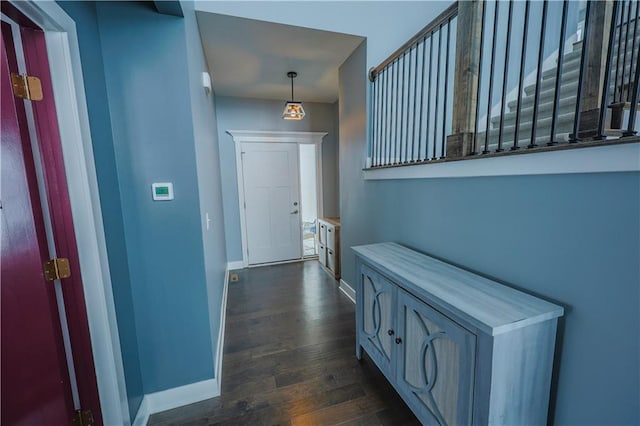 hall with dark wood finished floors and baseboards