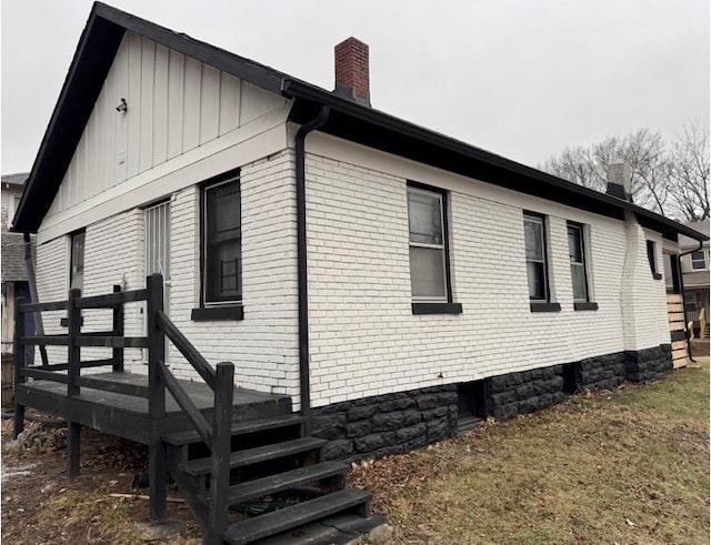 view of home's exterior featuring a wooden deck and a lawn