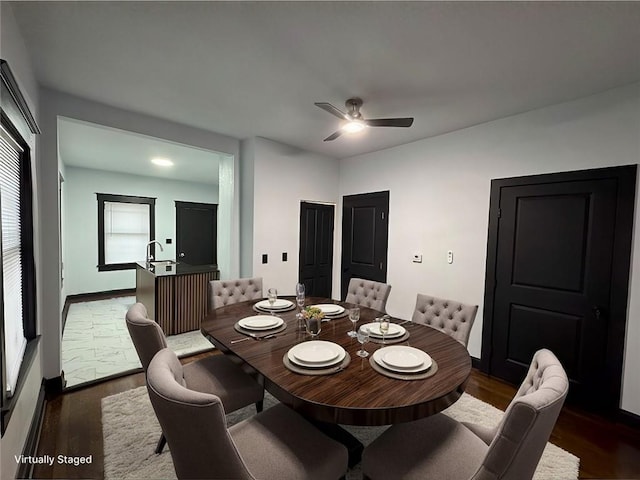 dining room with dark wood-type flooring and ceiling fan