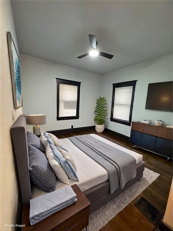 bedroom featuring ceiling fan and dark hardwood / wood-style floors