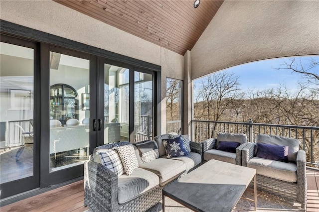 wooden terrace with outdoor lounge area and french doors