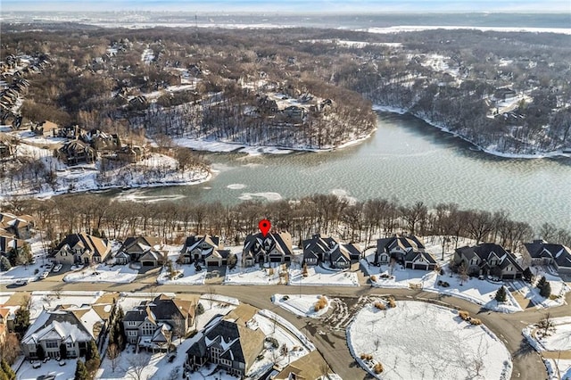 snowy aerial view with a water view