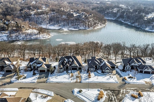 snowy aerial view featuring a water view