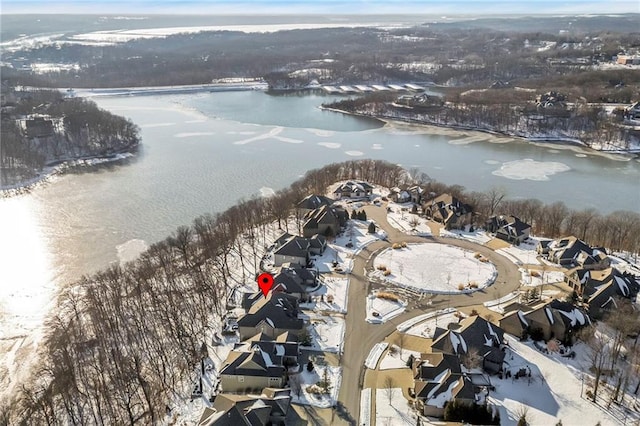 snowy aerial view with a water view