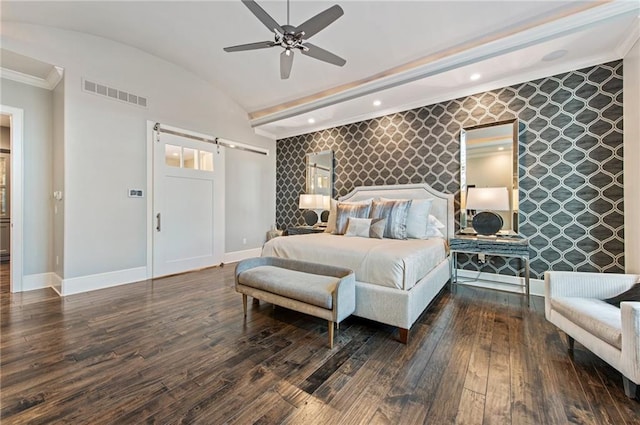 bedroom featuring ceiling fan, a barn door, vaulted ceiling, and dark hardwood / wood-style flooring