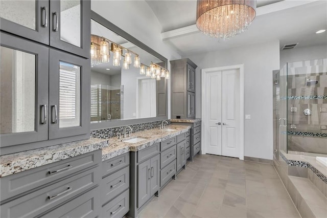 bathroom with backsplash, vanity, separate shower and tub, and a notable chandelier