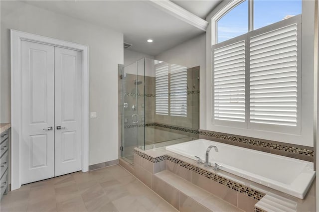 bathroom featuring vanity, independent shower and bath, and tile patterned flooring