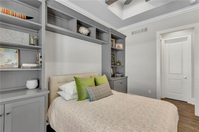 bedroom with ceiling fan, dark wood-type flooring, and ornamental molding