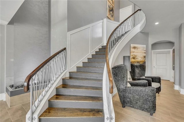 staircase with a towering ceiling