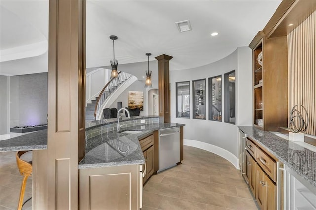 kitchen featuring a kitchen breakfast bar, dark stone countertops, dishwasher, and hanging light fixtures