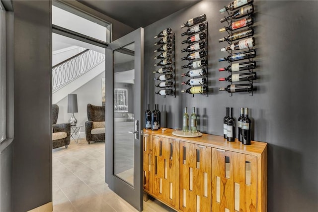 wine room with light tile patterned floors and indoor bar