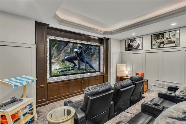 carpeted home theater room featuring a tray ceiling