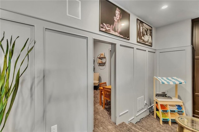 mudroom with light colored carpet