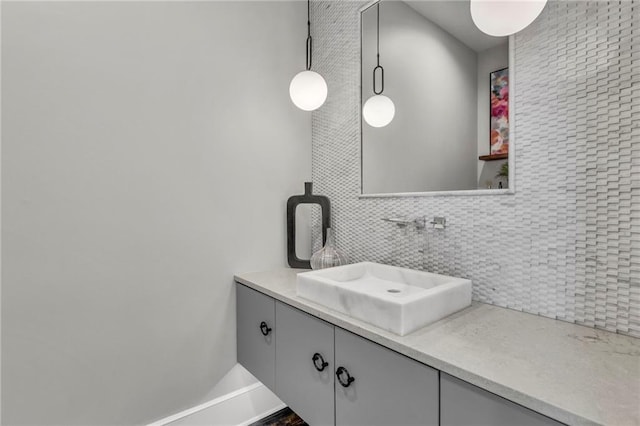 bathroom featuring vanity and decorative backsplash