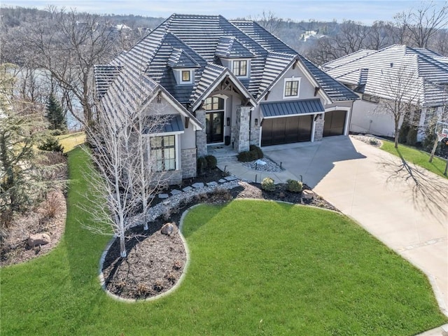 view of front of home with a garage and a front lawn