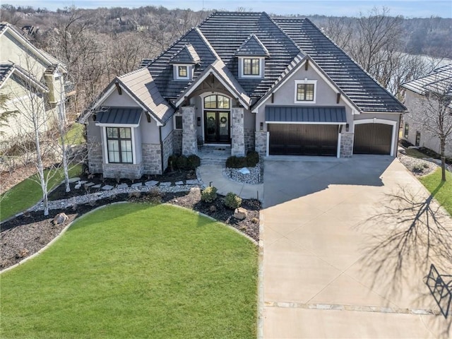 craftsman-style house featuring a garage and a front lawn