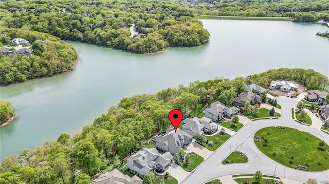 6069 Southlake Dr, Parkville, MO 64152 - aerial perspective of suburban area with a large body of water and a heavily wooded area
