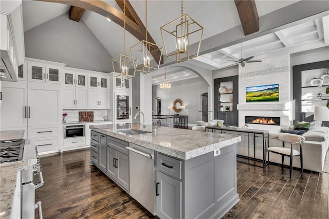 6069 Southlake Dr, Parkville, MO 64152 - kitchen with a sink, stainless steel appliances, beamed ceiling, gray cabinets, and arched walkways