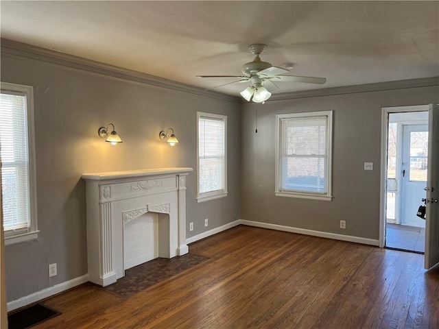 unfurnished living room featuring dark wood-type flooring, ceiling fan, a wealth of natural light, and a fireplace