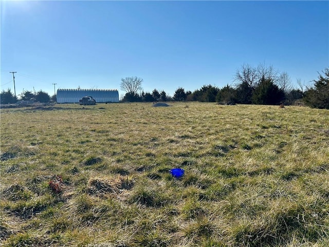 view of yard with a rural view