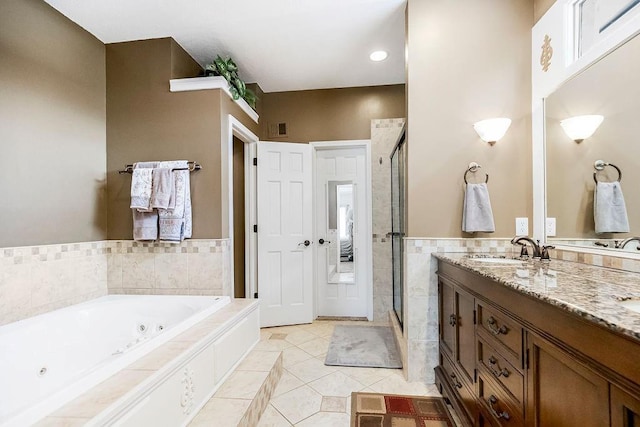 bathroom featuring tile walls, shower with separate bathtub, vanity, and tile patterned flooring