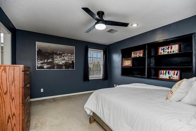 bedroom featuring a textured ceiling, ceiling fan, and carpet flooring