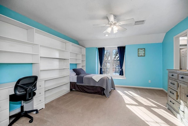 carpeted bedroom with vaulted ceiling and ceiling fan