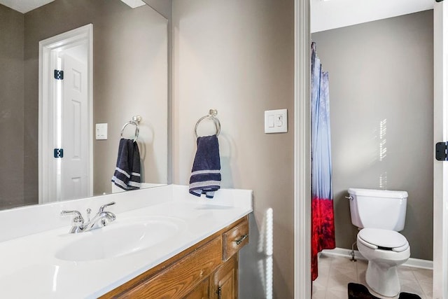 bathroom with vanity, tile patterned flooring, and toilet