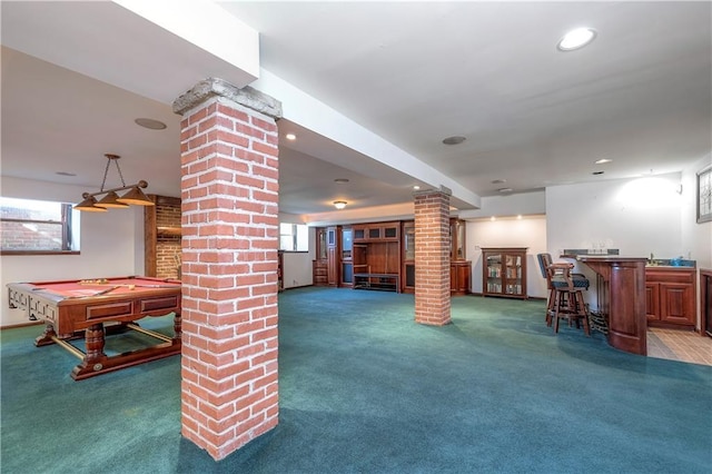 recreation room featuring pool table, carpet floors, decorative columns, and indoor bar