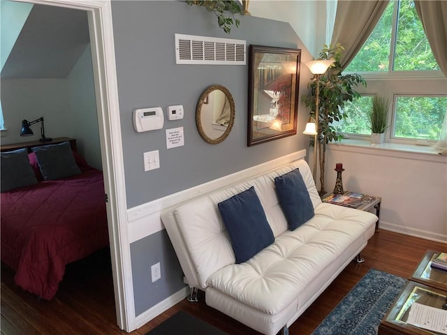 bedroom with dark wood-type flooring and vaulted ceiling