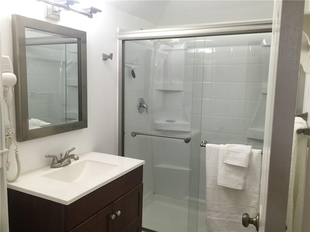 bathroom with an enclosed shower and vanity