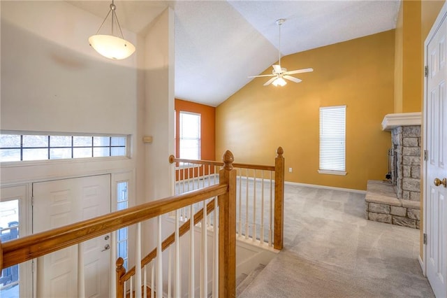 hall featuring light carpet and vaulted ceiling