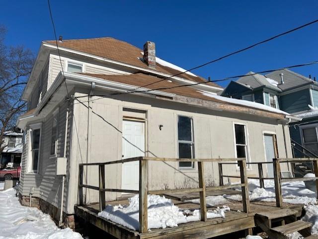 view of snow covered rear of property