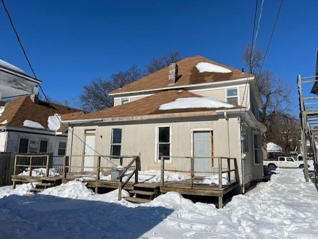 snow covered property with a wooden deck