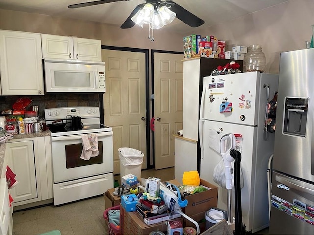 kitchen featuring white appliances and white cabinets