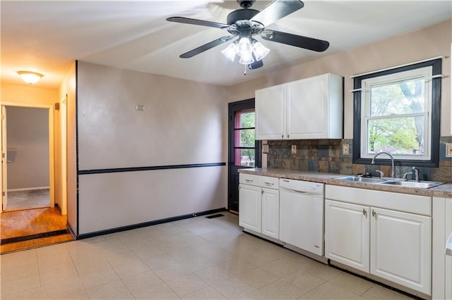 kitchen featuring a sink, plenty of natural light, white cabinetry, and dishwasher