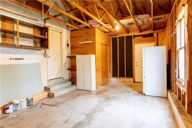 miscellaneous room with unfinished concrete floors