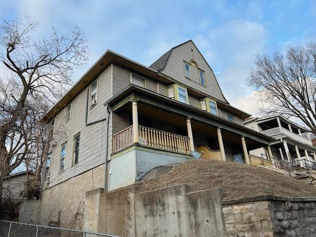 view of side of home featuring a balcony