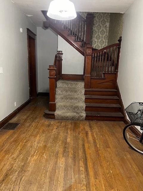 stairs with hardwood / wood-style flooring