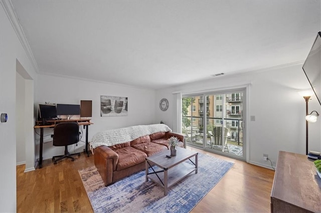 living room featuring wood-type flooring and ornamental molding