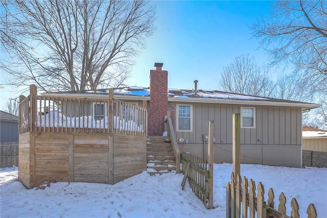 view of snow covered back of property