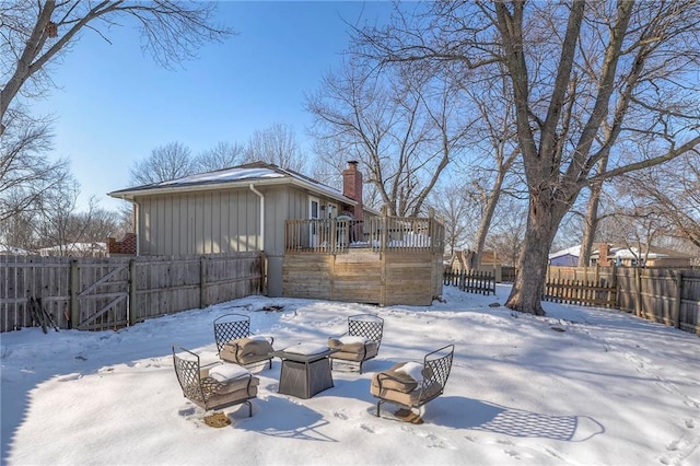 yard layered in snow with a wooden deck