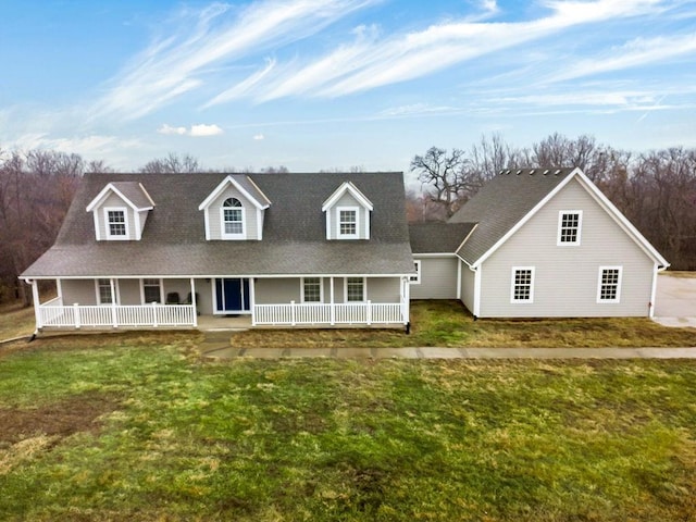 cape cod-style house featuring a porch and a front lawn