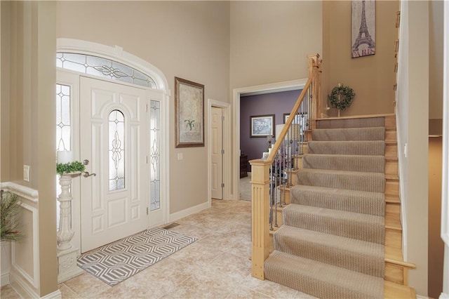 foyer entrance with a high ceiling and light tile patterned floors