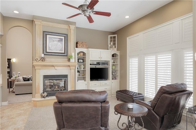 tiled living room featuring ceiling fan