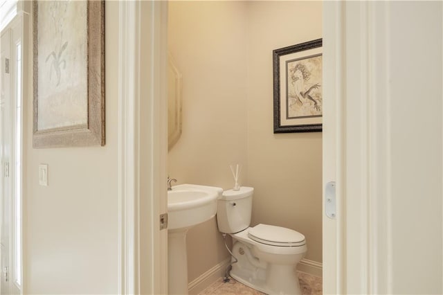 bathroom with toilet and tile patterned flooring