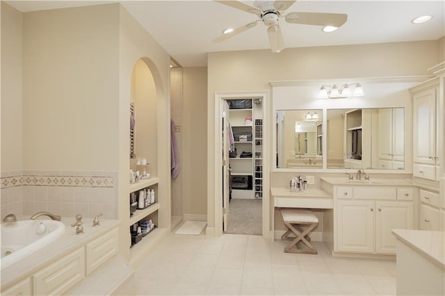 bathroom featuring a bathtub, ceiling fan, tile patterned floors, and vanity