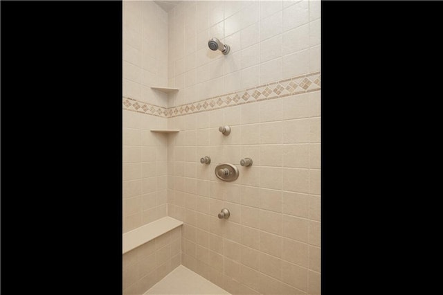 bathroom with a tile shower